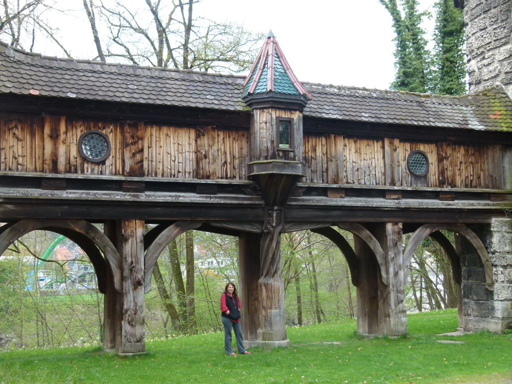 Lori underneath the wooden walkway between the two buildings.