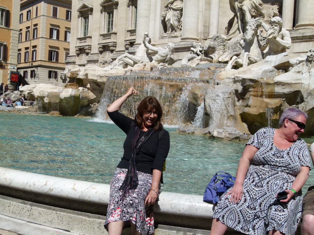 Lori tossing a coin into the fountain.