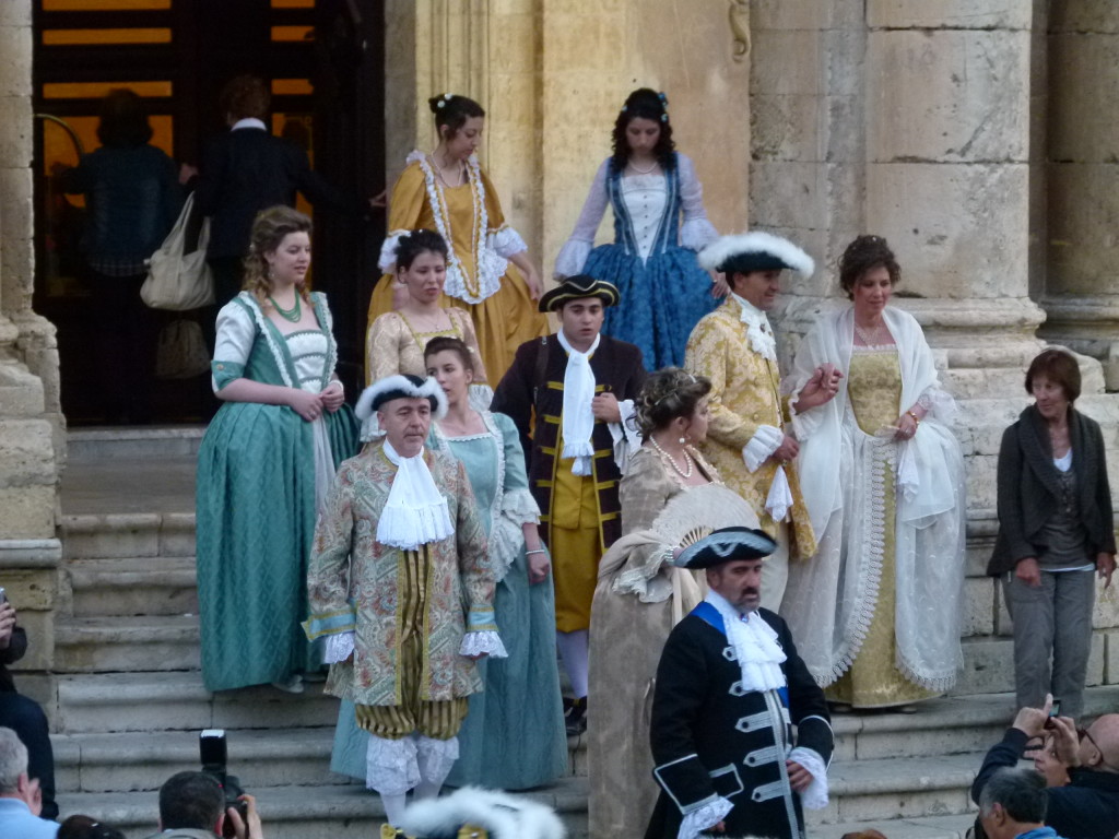 People dressed in costume for a promenade which we thought was going to be a parade.