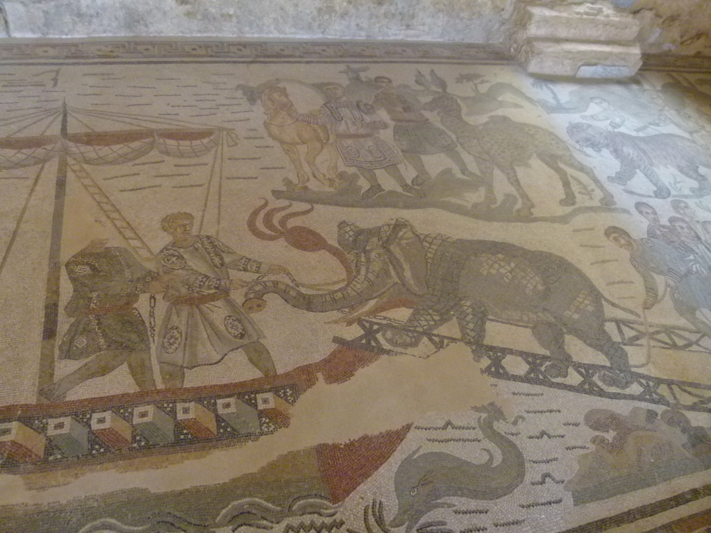 A scene with an elephant being loaded onto a ship.