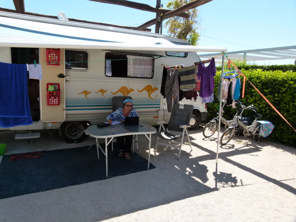 Our campsite with bikes, washing and Jenny doing some planning for our Greek leg of our trip.