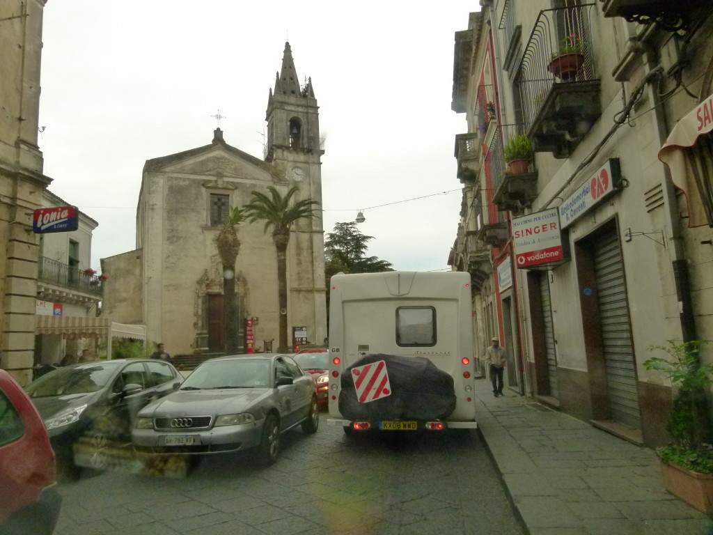 Clyde and Anna driving through some narrow streets.