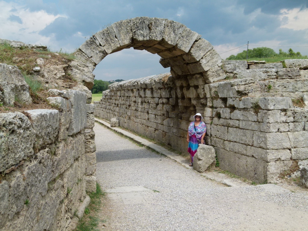 Jenny at the archway to the track where the ancient Olympics were held.