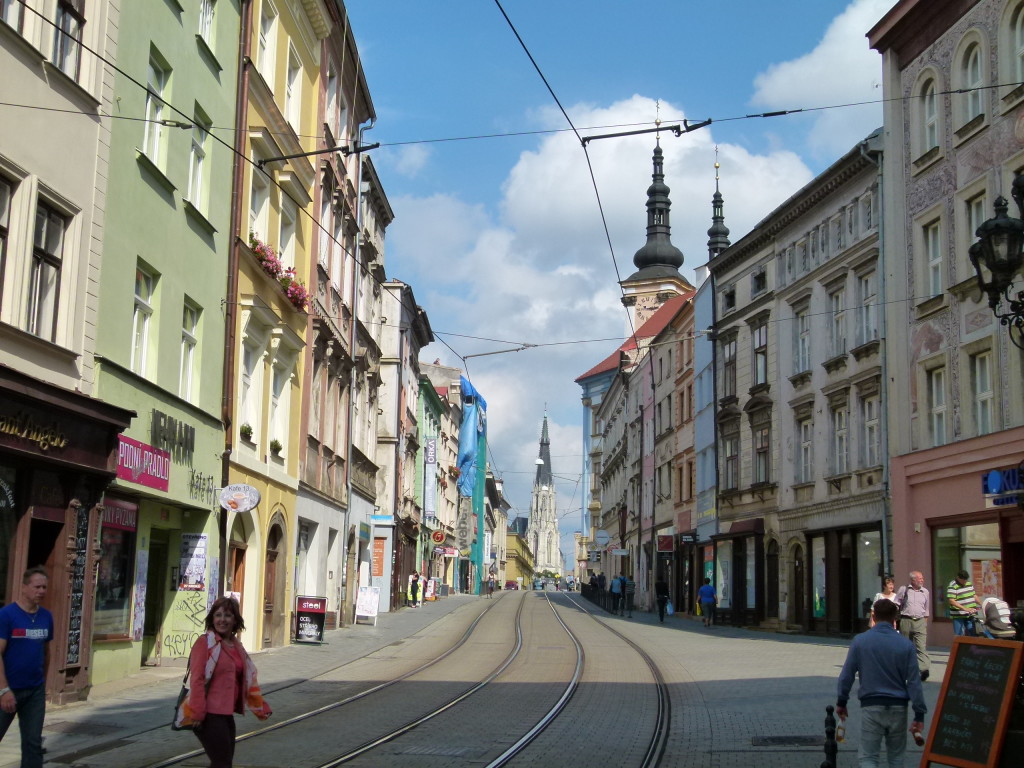 Streetscape of Olomouc, with tram lines running down the road.