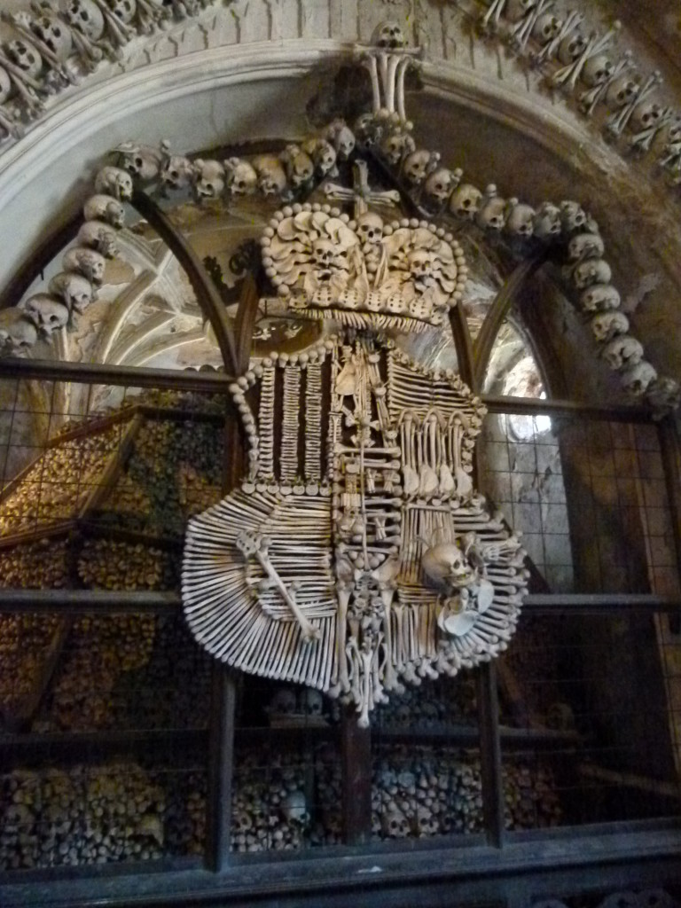 Behind the crest made of bones is a large stack of bones. This was one of several stacks ib the chapel.