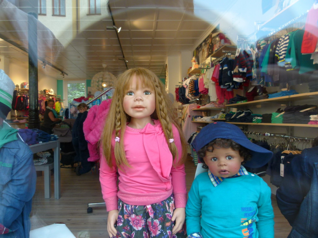 life like mannequins in a clothes shop window. We think the girl looks very much like one of our granddaughters.