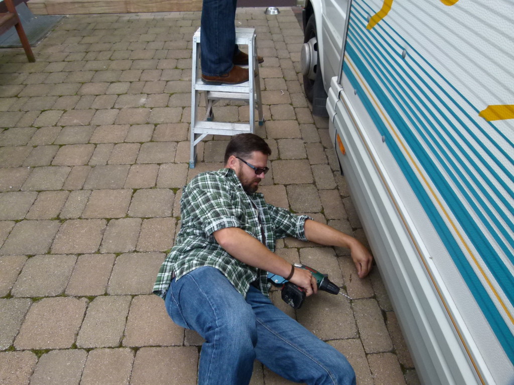 Micheal putting in a new bolt where the panel had come apart.