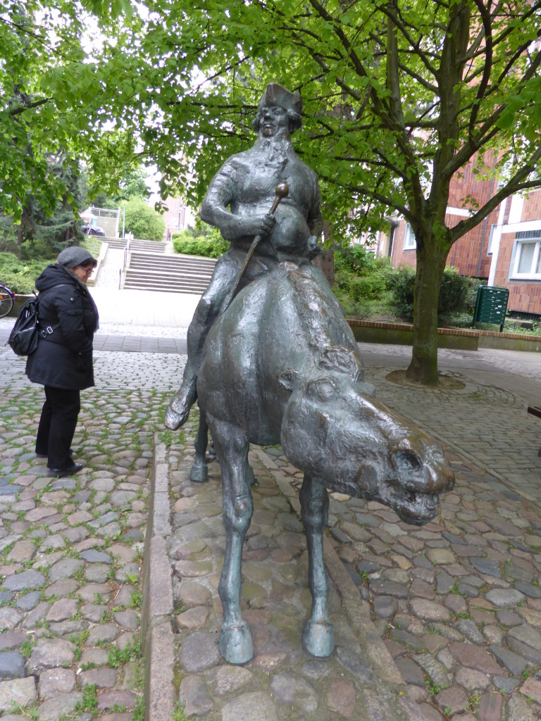 As we entered the old city of Rostock this statue was in a small street. In the next photo see what Jenny is looking at.