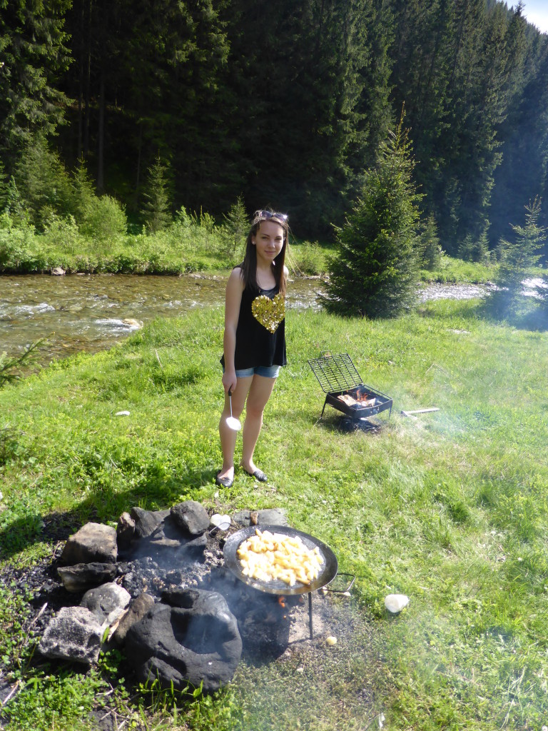 Cooking dinner over an open fire.