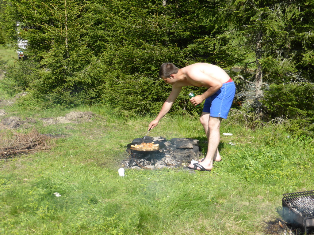 Gabrelle turning over the chicken.