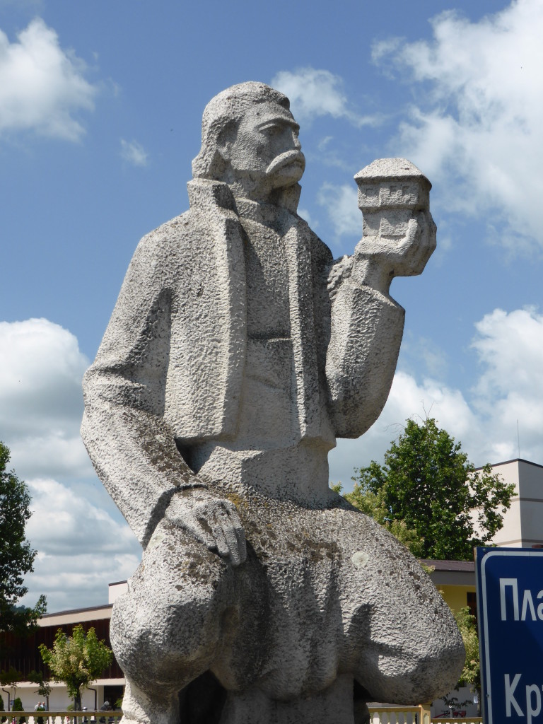 Not sure why he is holding up a building, my guess is that he may be an architect.