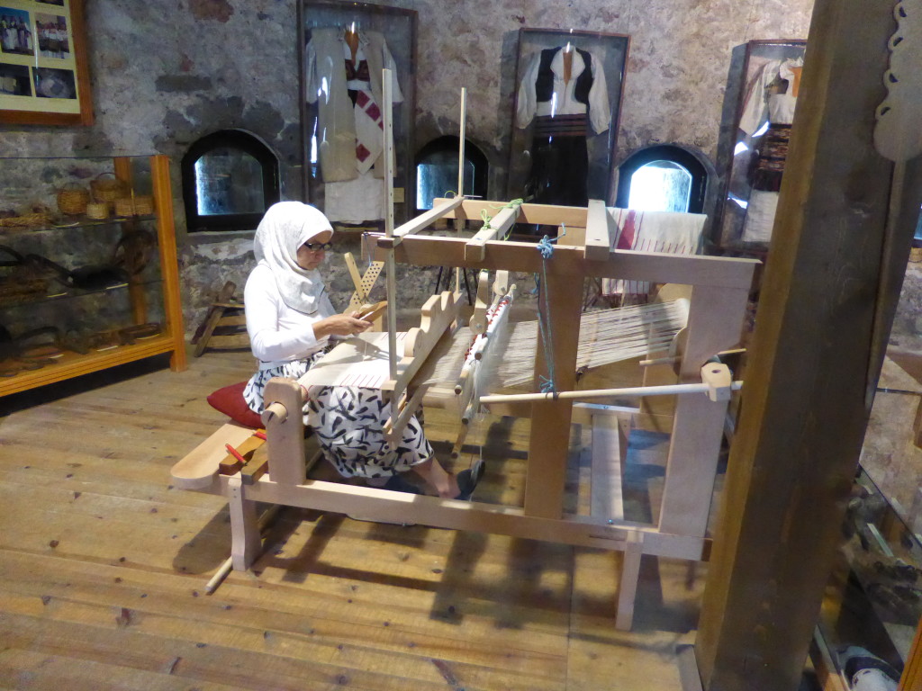 In the large circular tower This lady was busy weaving amongst examples of traditional work.